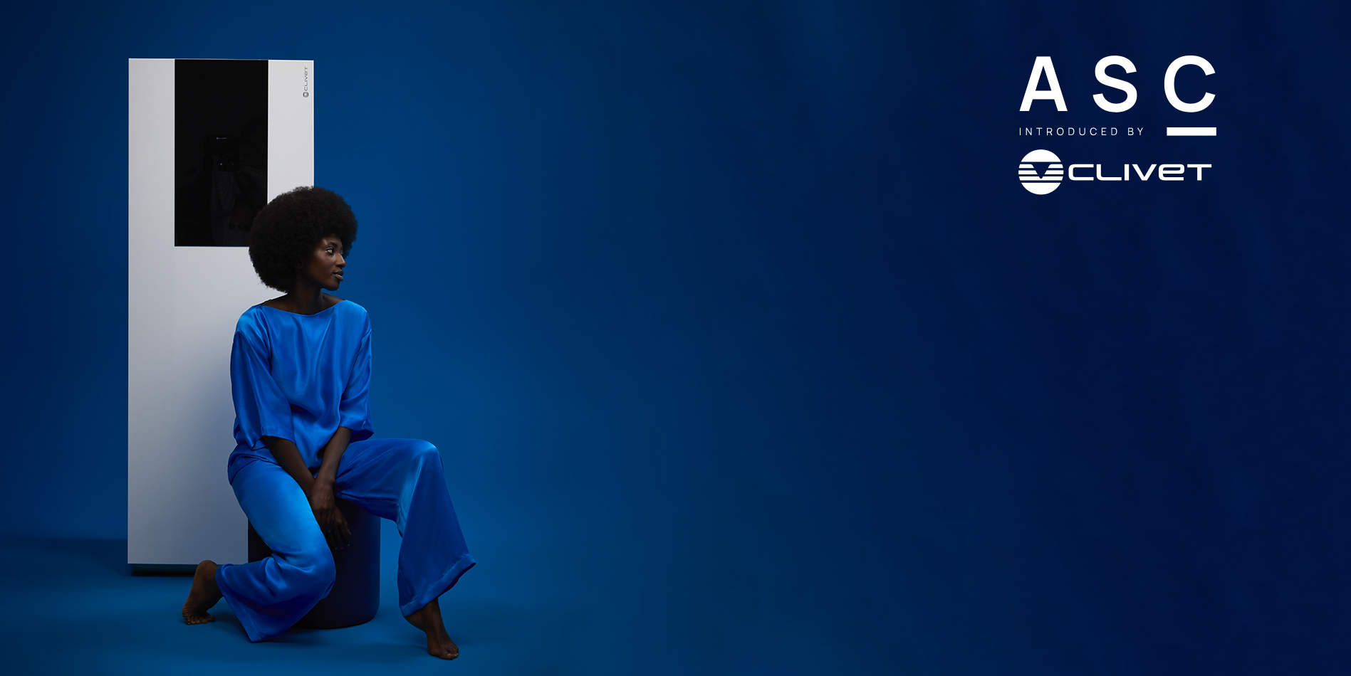 ALL SEASONS COLLECTION, a home fashion collection to prove that comfort starts with your surroundings. Blue setting, girl sitting with a Clivet heat pump behind her.